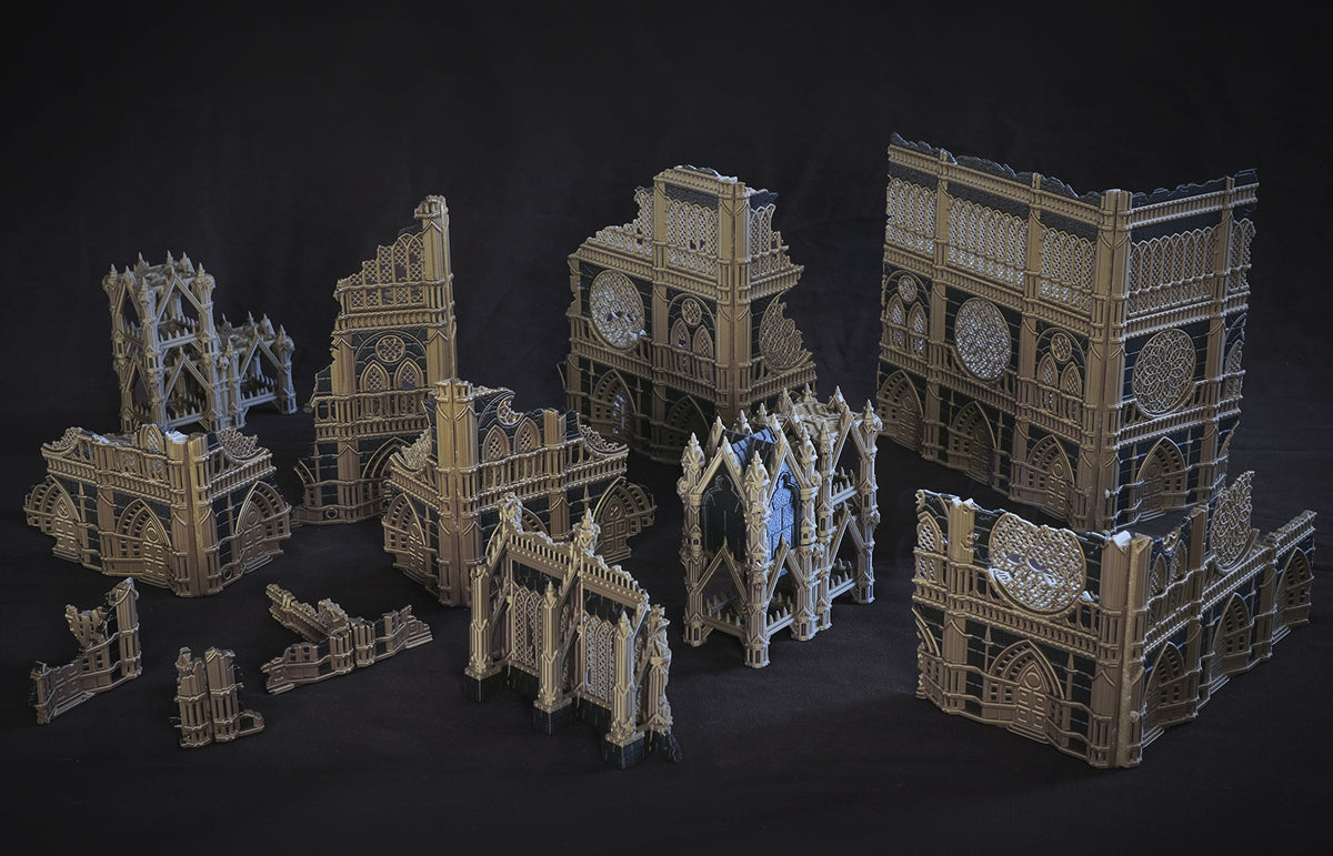 Assembled MiniForge foldable terrain set: gothic ruined buildings, shrine, and scatter pieces printed in bone and dark blue