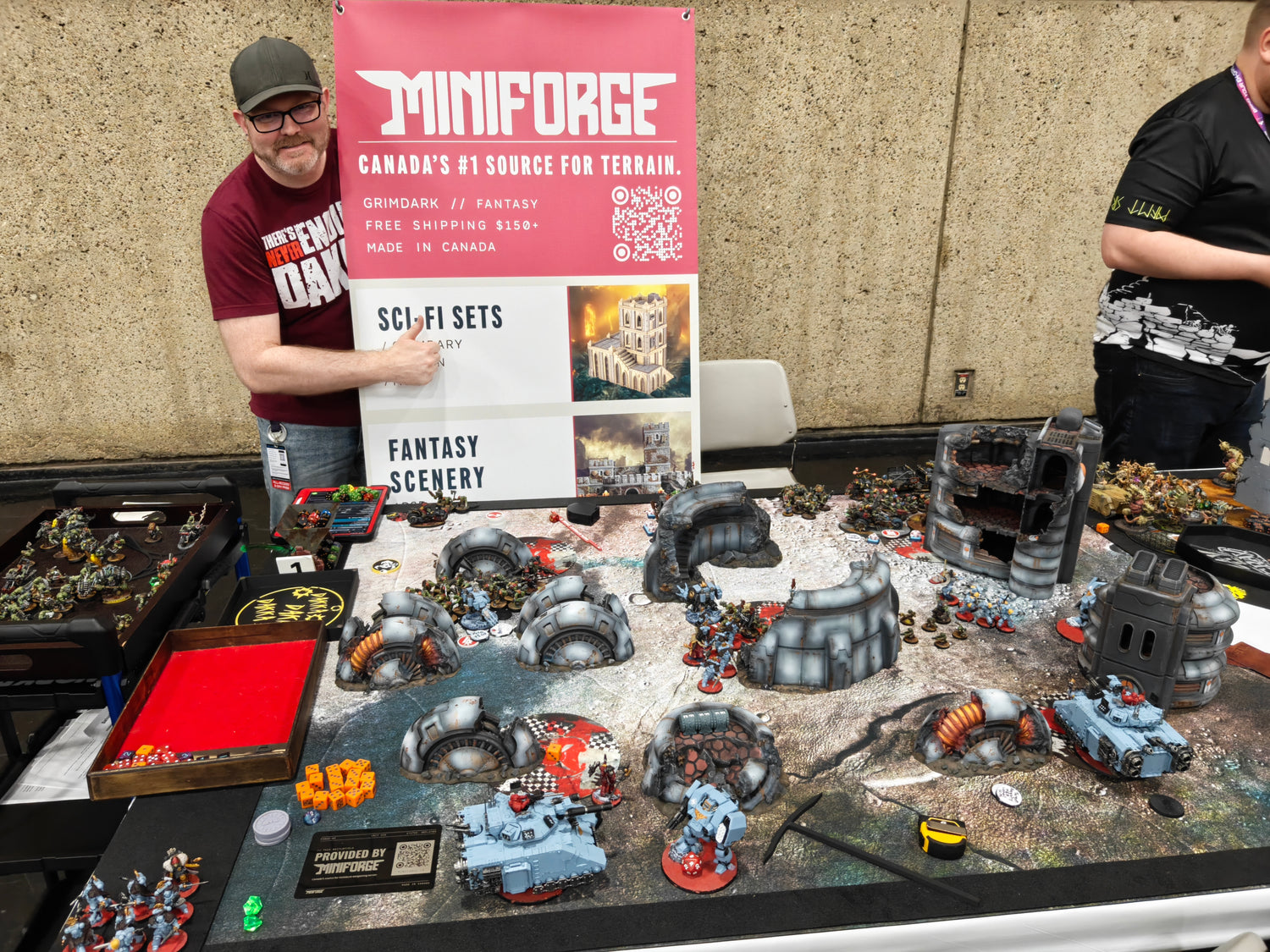 MiniForge booth at a Warhammer 40K tournament with 3D printed sci-fi and fantasy terrain on display, Canada